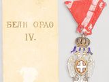 an image of a medal with a red ribbon and a cross on it