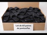 a cardboard box filled with lots of black shoes