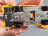 a person holding a toy train in their hand