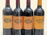 three bottles of red wine are lined up on a white surface