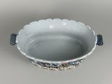a blue and white bowl with a flower design on it