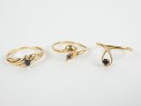 a set of three gold rings with sapphire stones