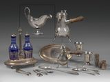 a silver plate and silverware on display on a table