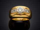 a close up of a gold ring with diamonds on a black surface