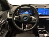 the interior of a car with a steering wheel, dashboard, and display screen