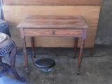 a small table with a bowl on it in a room