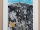 painting of rocks and plants in a wooden frame on a wall