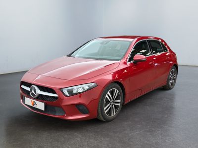 a red mercedes cla parked in a white room