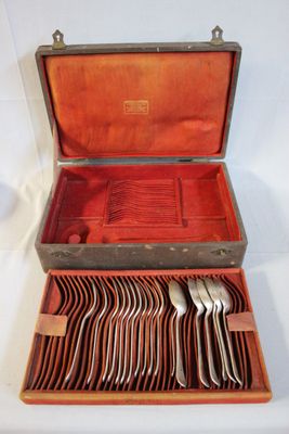 a wooden case with silverware in it on a white surface