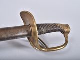 an old sword with a metal handle on a white surface