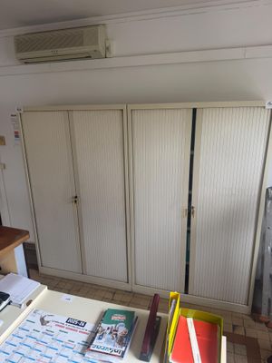 a kitchen with a stove, refrigerator, and a refrigerator freezer in it