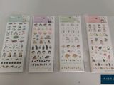 four different types of stickers in plastic bags on a table