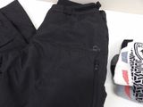 the black pants are next to a pair of socks and a backpack