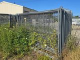 a fence that has a bunch of plants growing out of it