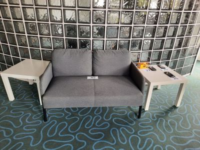 a couch and a table in a room with a glass wall behind it