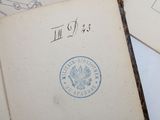 an old book with a stamp on it sitting on top of a table
