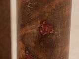 a close up of a piece of wood with a red spot on it