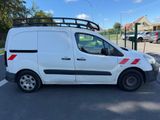 a white van parked in a parking lot next to a parking lot