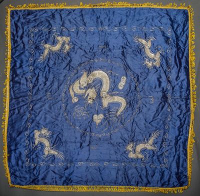 a blue and gold silk table cloth with a picture of a man and a woman