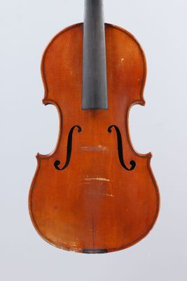 an old violin with a bow hanging from it ' s back