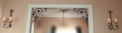une photo d'un miroir dans une pièce où des bougies sont accrochées au mur