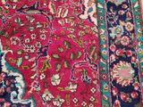 an oriental rug on a white floor with a cat laying on top of it