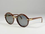 a close up of a pair of sunglasses on a white surface