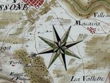 a close up of a map with a compass on it