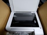 a printer that is sitting in a box on the floor