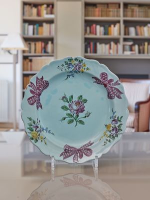 a blue plate with flowers on it sitting on a table