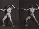 black and white photograph of a naked woman posing in front of a mirror