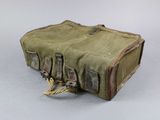 a small green bag with two handles on a table
