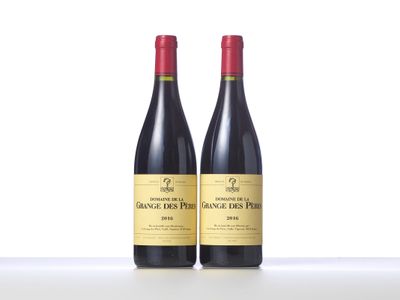 two bottles of red wine sitting on top of a table