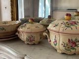many dishes on a table with a mirror in the background