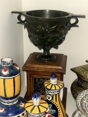 many different vases and bowls on the table