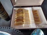 many spoons and forks in a case on the table