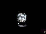 a close up of a diamond on a black surface