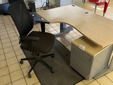 a desk with a chair and a computer on it