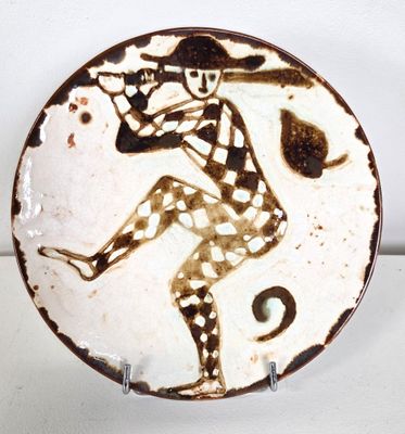 a brown and white plate with a picture of a man on it