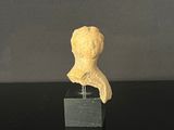 a small statue of a woman on a black table