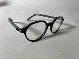 a pair of glasses sitting on a white surface