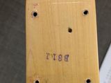 a wooden skateboard that is sitting on top of a table