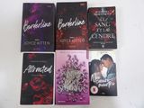 four paperbacks of romance novels sitting on a white surface