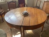 a wooden table with a bowl on it in the middle of a room