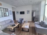 an image of a living room with couches and coffee tables