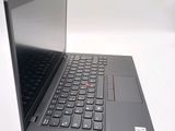 a black laptop with a red button on the keyboard