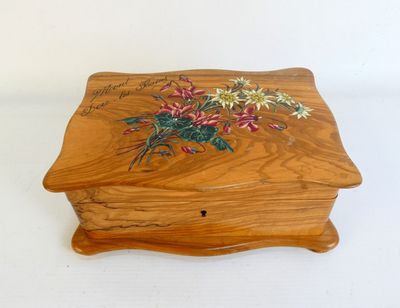 une image représentant une boîte en bois sur laquelle sont peintes des fleurs