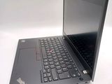 a laptop with a black keyboard sitting on a white surface