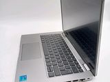 a silver laptop with a blue sticker on it