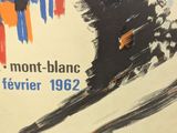 a poster with a picture of a man skiing down a hill